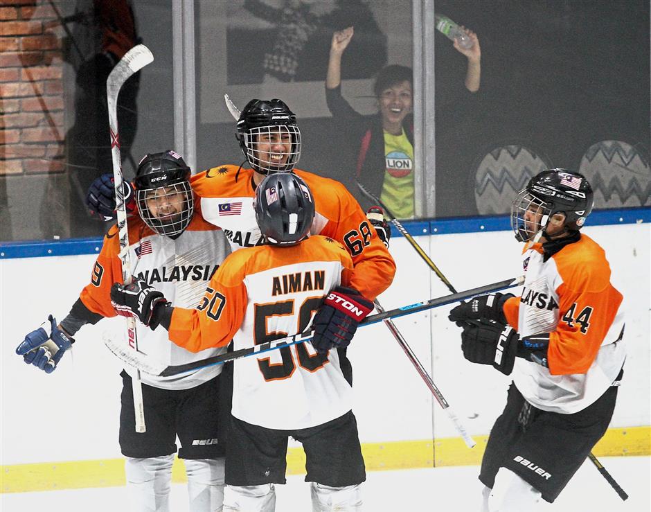 Team Malaysia celebrating after scoring a goal against Macau in the final.