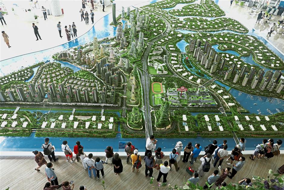 Urban greenery: A file photo of prospective buyers looking at a model of development at CGPV’s Forest City showroom in Johor Baru. — Reuters