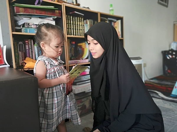 Heavy responsibility: Putri with her two-year-old daughter.