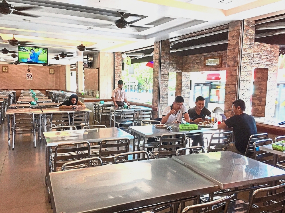 The restaurant is spacious and comfortable, with flat TV screens and ceiling fans.