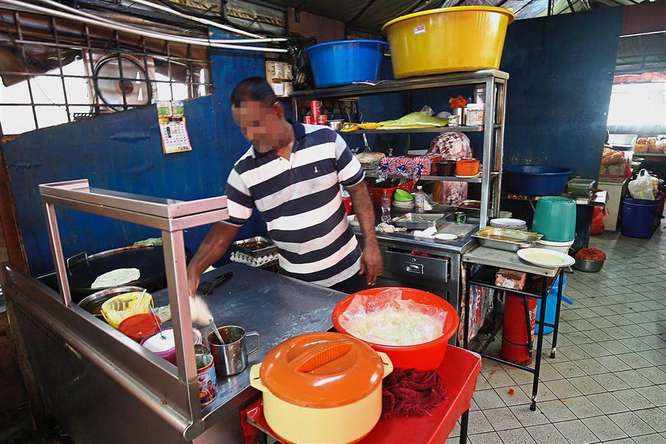 A food handler not wearing an apron or cap is a clear violation of hygiene rules.