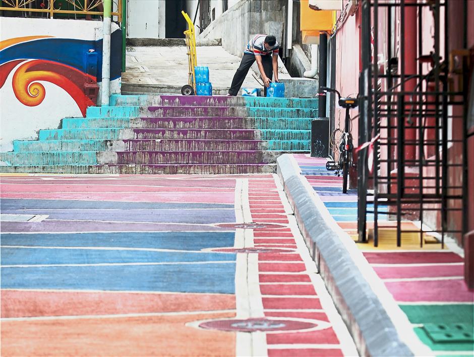 A man painting the steps in one of the city’s backlanes.