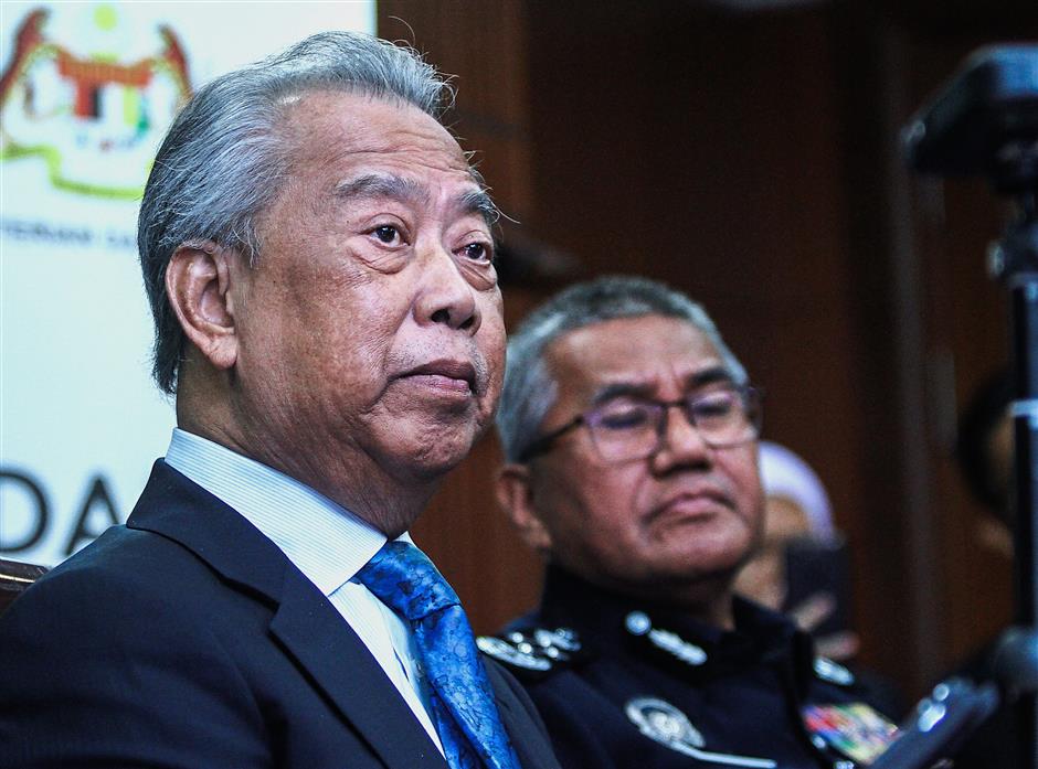 Latest update: Muhyiddin speaking to reporters during a press conference in Putrajaya as Mohamad Fuzi looks on.