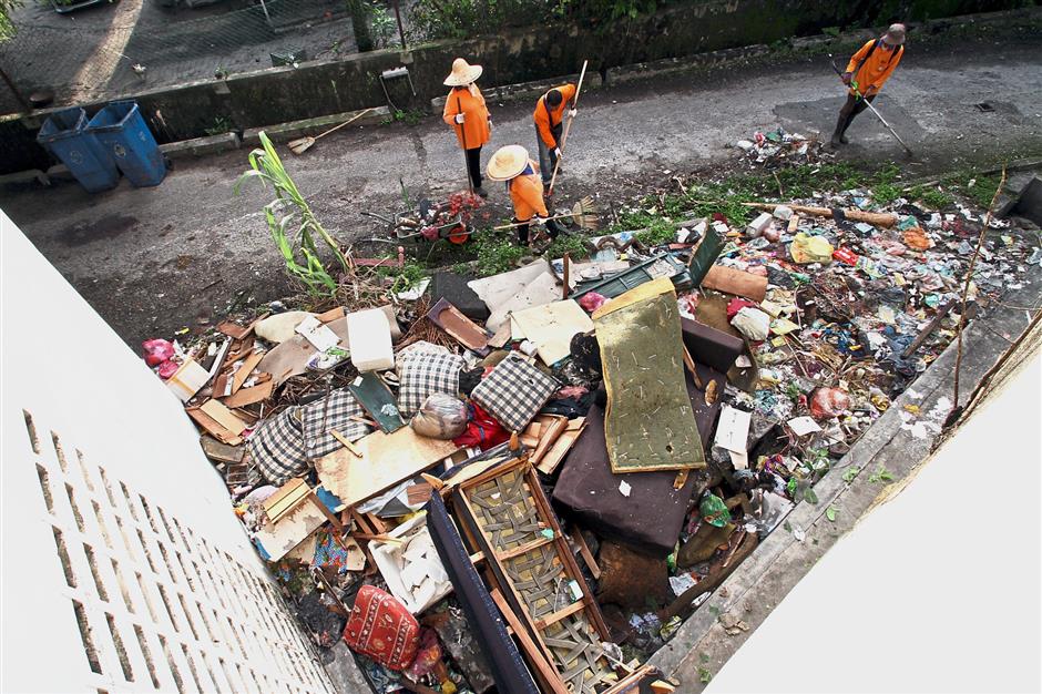 (Left) Cleaners had a busy day clearing rubbish which included furniture and appliances.
