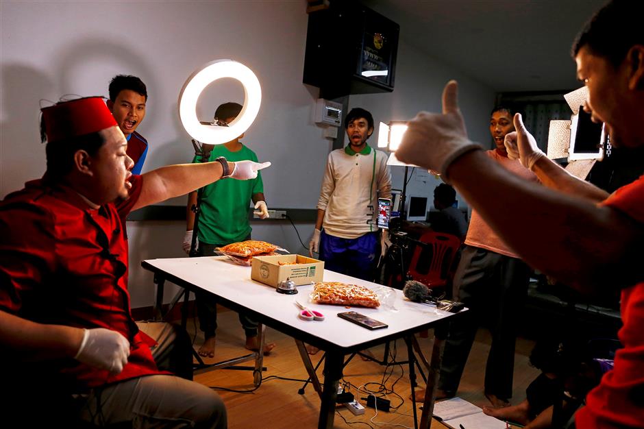Anurak Sareuthai sells dried seafood products with his colleagues during a Facebook live event at his house in Satun province, southern Thailand, May 30, 2019. Picture taken May 30, 2019. REUTERS/Jiraporn Kuhakan NO RESALES. NO ARCHIVES.
