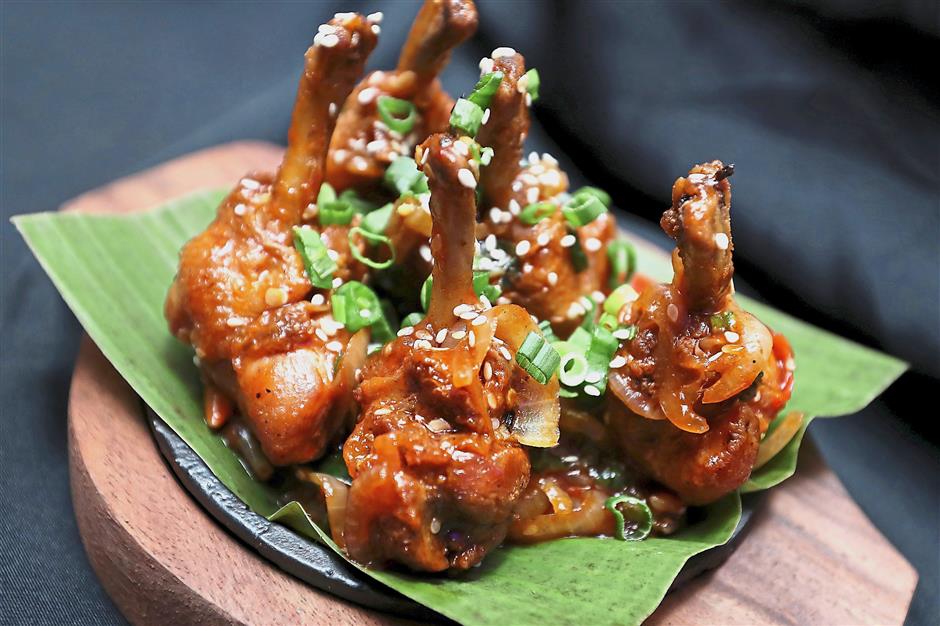Spicy Chicken Lollipop comprises chicken drumettes grilled in a spicy and sweet glaze.