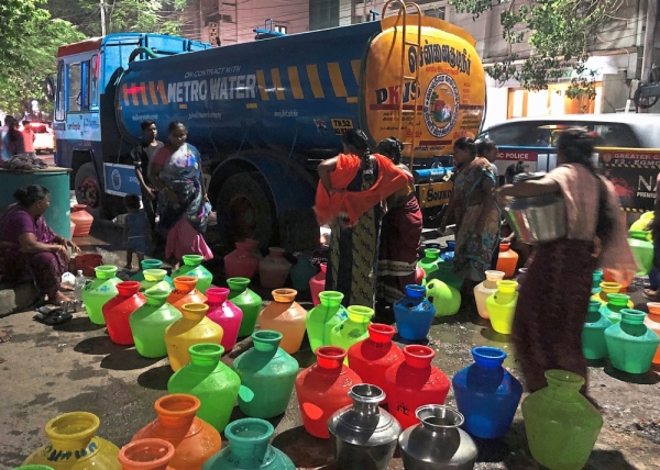 Daily struggle: Chennai’s womenfolk lining up at night to collect water in ‘kudams’ or bright plastic pots.