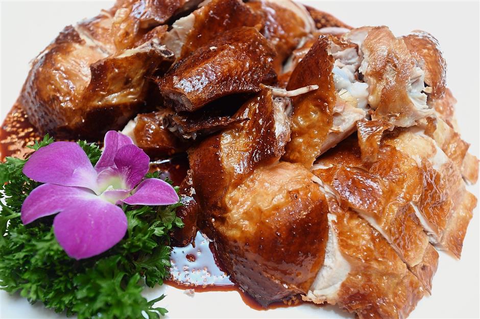 Crispy Roasted Chicken with spicy sesame vinegar sauce is available in the prosperity menu.