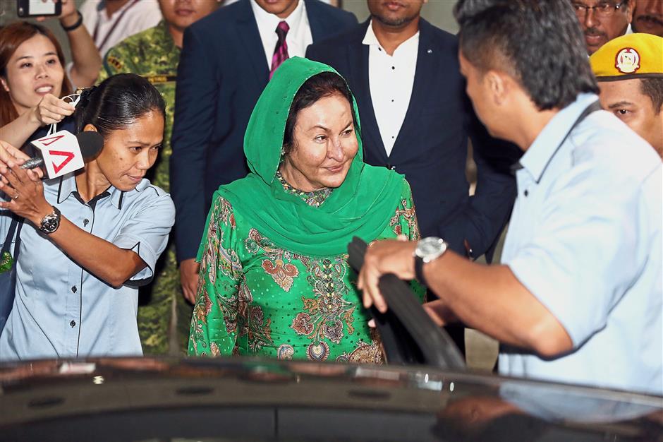 Done at last: Rosmah smiling at reporters as she leaves the MACC building.