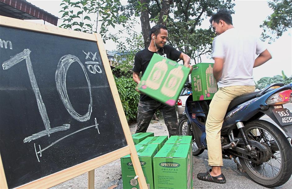 Bottled water and containers selling like hot cakes during the water cut in Taman Medan, Petaling Jaya.