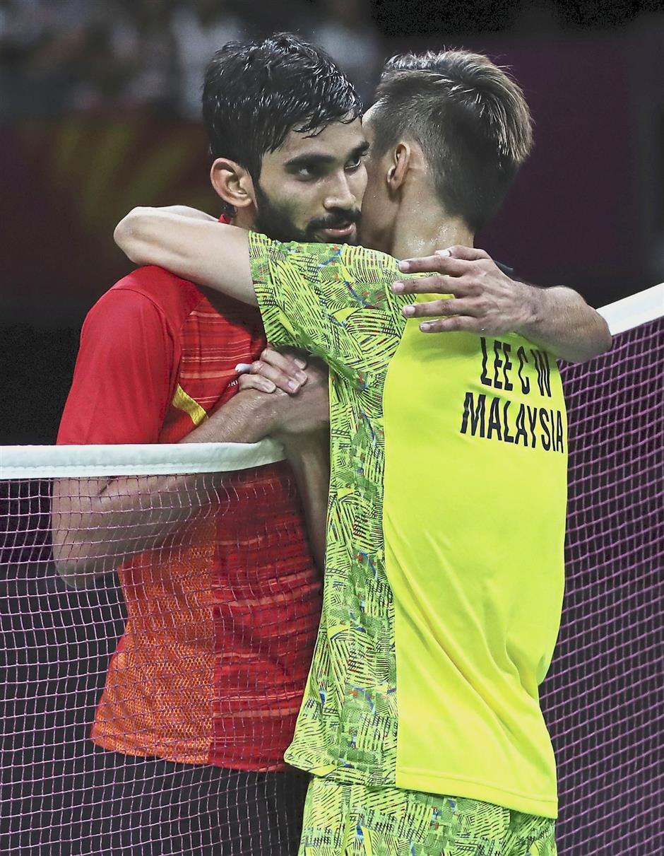 In rapture: Lee Chong Wei celebrating after winning the men’s singles gold. He beat India’s K. Srikanth 19-21, 21-14, 21-14 in the final.