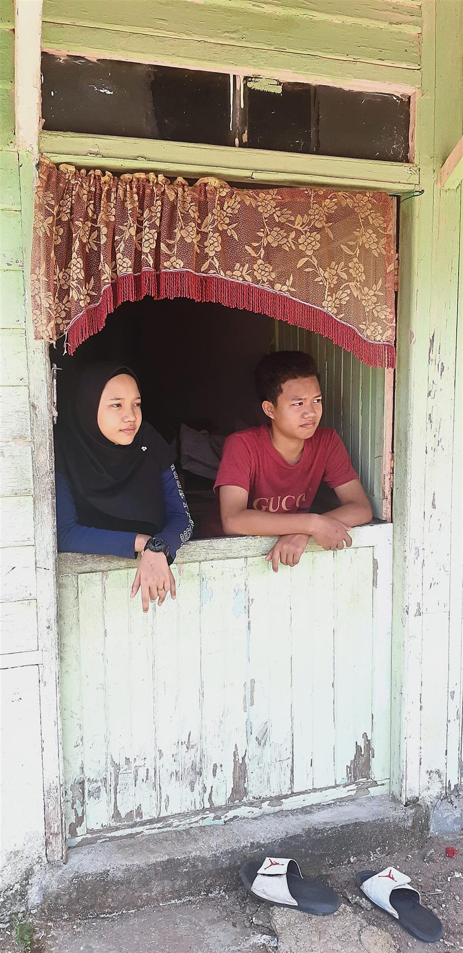 Calm and capable: Siti and Ridzwan at their rented house in Kampung Pinang Tengah. She will receive aid from the Melaka Welfare Dept.
