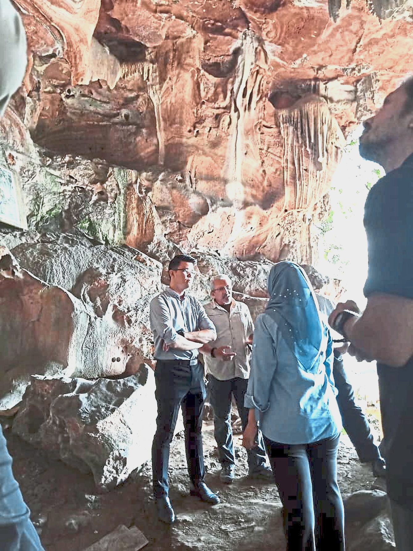 Tan (left) sharing a conversation with government department representatives during his site visit to Gua Naga Mas.
