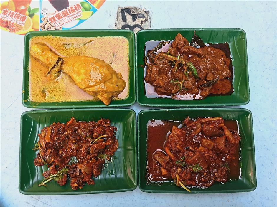 (Above) The side dishes one can enjoy with the nasi lemak include (clockwise, top left) ayam masak lemak, mutton curry, sambal sotong and sambal kerang.