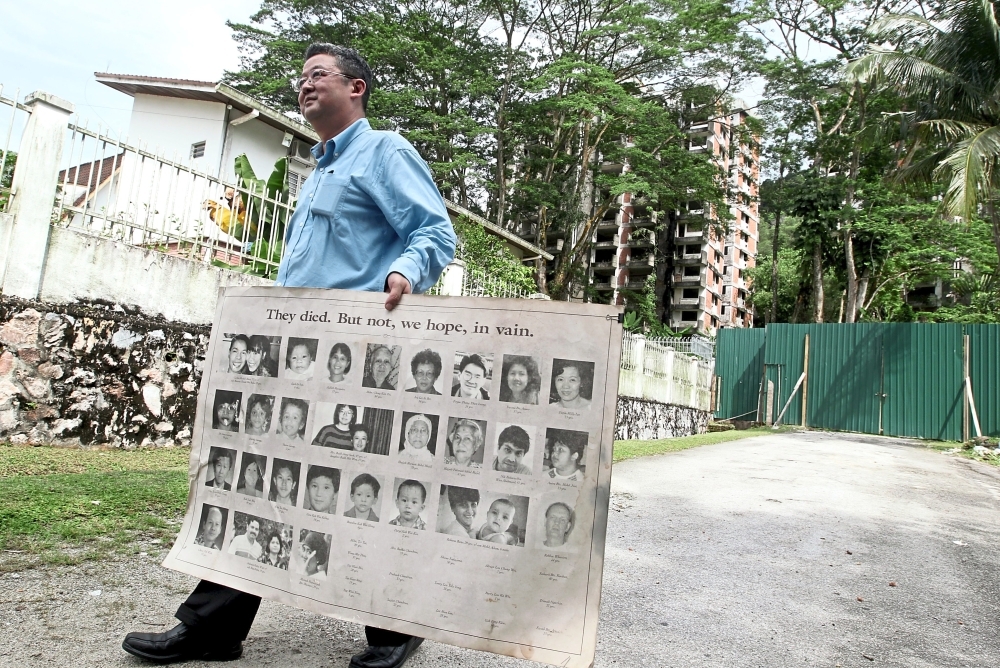 (Left)Chan with the poster of the victims during his visit to the Highland Towers site to commemorate the 20th anniversary of the collapse. — filepic