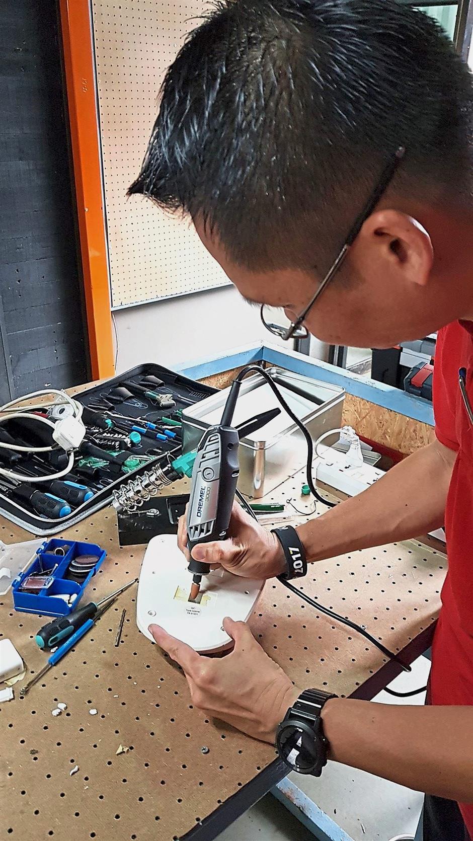 KakiDIY founder Johnson Lam takes a hands on approach when teaching how to fix stuff at the KakiRepair programme.