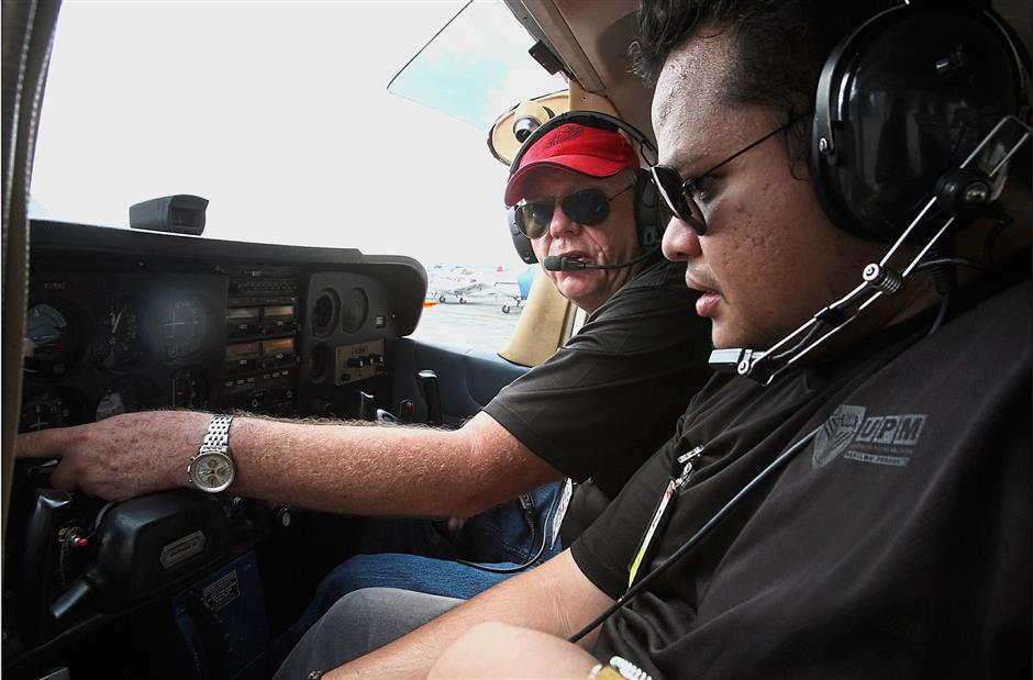 Walther and Muhammad Fakhrul go through engine startup checklists to commence the flight.