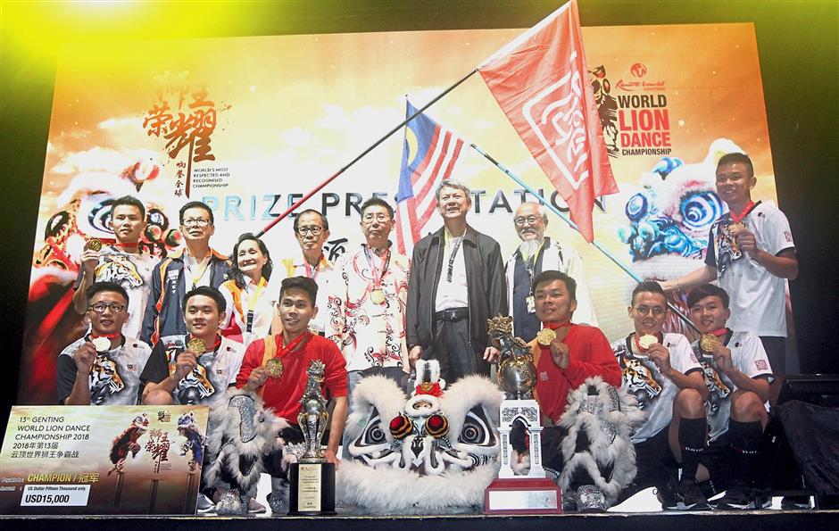 Champion Kun Seng Keng Lion and Dragon Association Muar, Johor posing with the champions and challenge trophy. — Photos: M. AZHAR ARIF/The Star