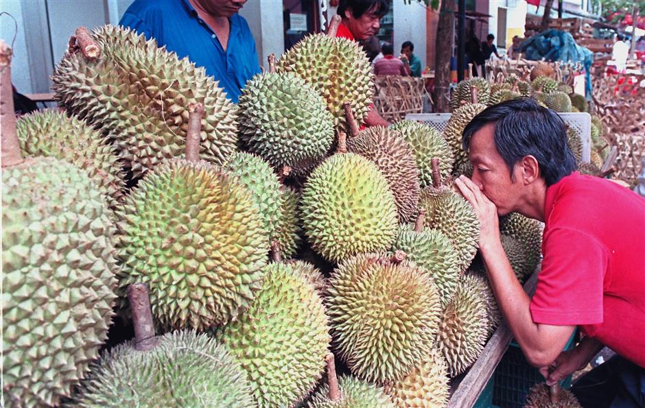 Most nutritious: A buyer sniffing for a good choice. Research has already been conducted from China to Singapore and yielded many positive benefits by indulging in the ‘king of fruits’. — Reuters