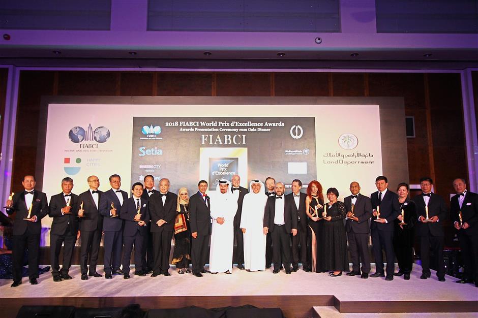 Prof Chen (seventh from left), Farook (ninth from left), (from 10th left) UAE Land Department audit head Muhammad Sultan, Fiabci World president elect Assen Makedonov and Falcon Developer chairman Salem Almoosa together with the Fiabci World Prix d’Excellence Awards 2018 World Gold Winners.