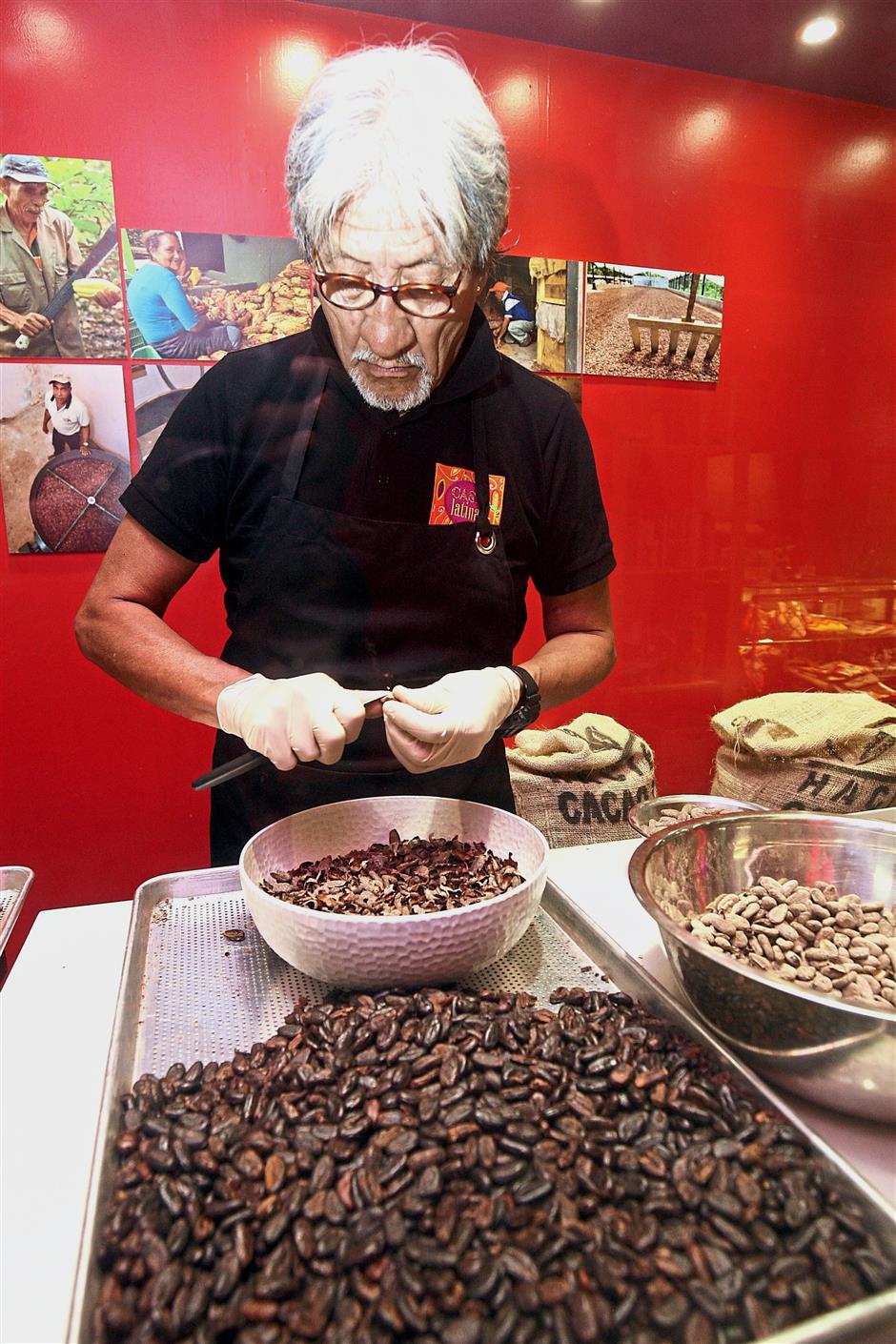 Sara dehusking cocoa beans.