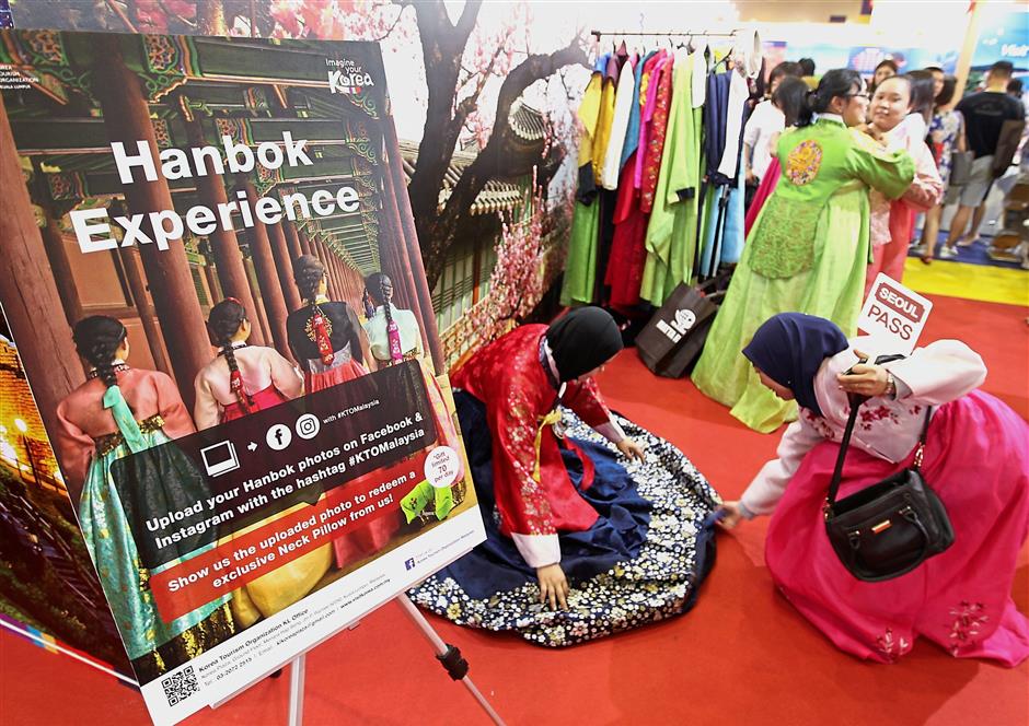 Visitors getting a taste of Korea as the Hanbok is showcased at the fair.