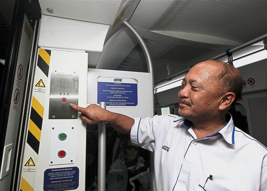 Khair shows the intercom which passengers can use during an emergency.