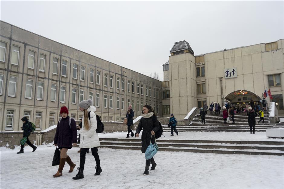 In this photo taken on Thursday, Dec. 20, 2018, students come out of the school building in St. Petersburg, Russia. Two Russian high school students, Leonid Shaidurov and Maxim Dautov, have irked their school by setting up an independent union to voice the students’ concerns. Faced with a backlash, the boys like many other young people in Russia, didn’t take the punishment lying down but went public on social media with their dispute with the principal. (AP Photo/Nataliya Vasilyeva)