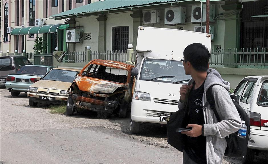 An abandoned car rusting away at the roadside near Masjid Jamek Simpang Enam in George Town.