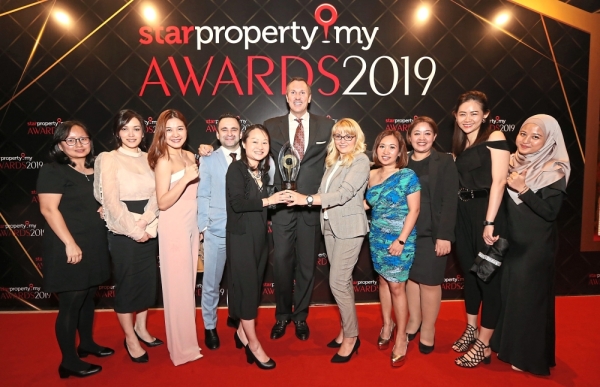 Four Seasons Hotel Kuala Lumpur senior marketing director Nelson Hilton (centre), sales manager Melissa Teo (fifth from left), Elvira Chelebiyeva (fifth from right) and the team are all smiles as the hotel was awarded Creative Touch City Hotel Award (Timeless) for the best interior design for hotel development.