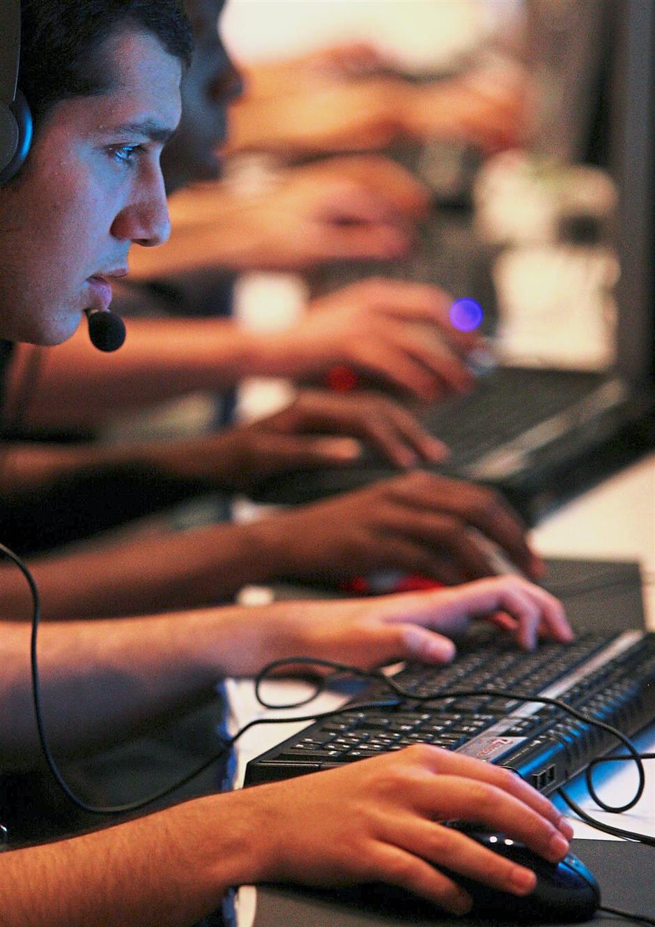 A file image of competitors in gaming tournaments during the World Cyber Games in Singapore in 2005. More than 700 computer game enthusiasts from 67 countries competed in 1,000 matches for a share of US435,000 in prize money. – Reuters