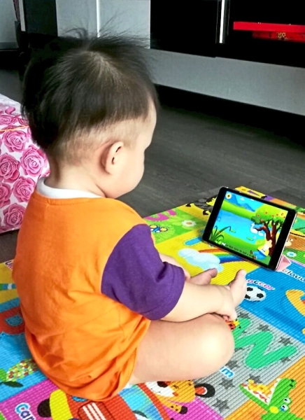 (Left) Even something as simple as playing with bubbles can be a great learning activity. (Far left) Toddlers should be discouraged from using the smartphone for long periods of time.
