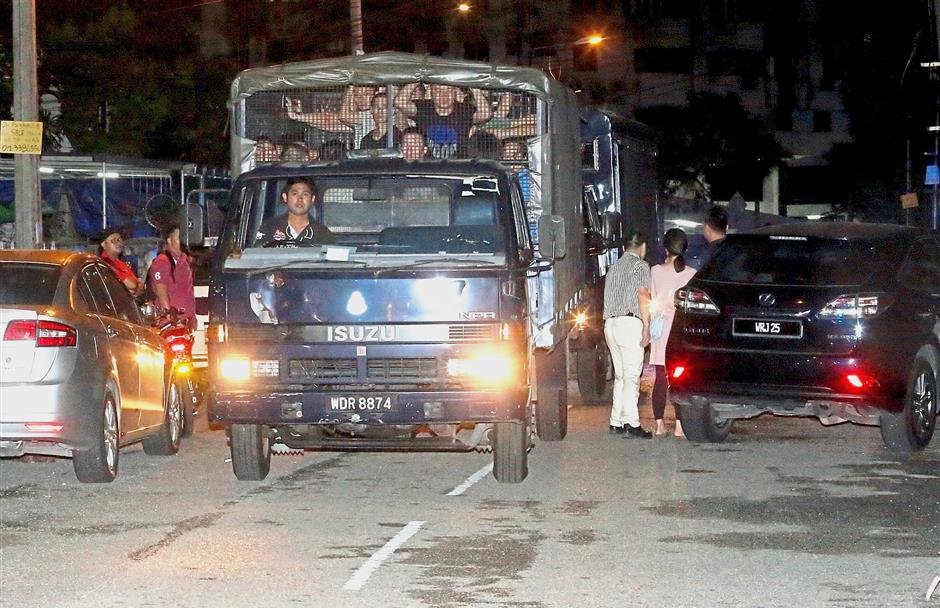 Rowdy lot: The Chinese nationals being taken away to Dang Wangi police headquarters.
