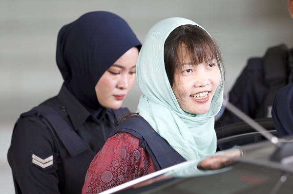 The end is near: A smiling Doan leaving the Shah Alam High Court. Inset: Her father Doan Van Thanh reacting outside the courthouse. — AP, AFP