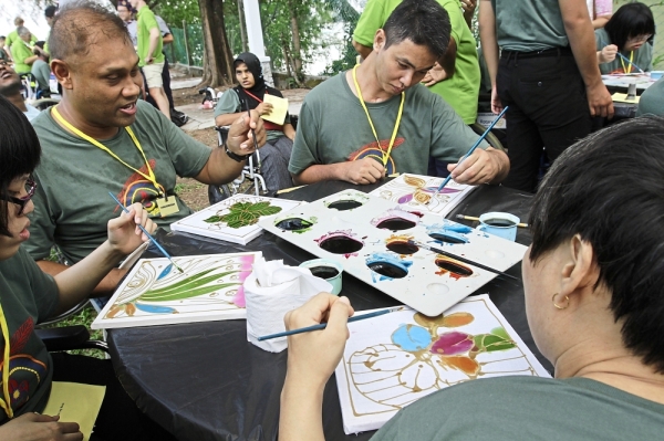 Participants painting batik at the 14th Penang Cheshire Agoonoree at Penang Water Sport Recreation Centre in Tanjung Bungah, Penang. StarPicby:LIM BENG TATT/The Star/23 March 2019.