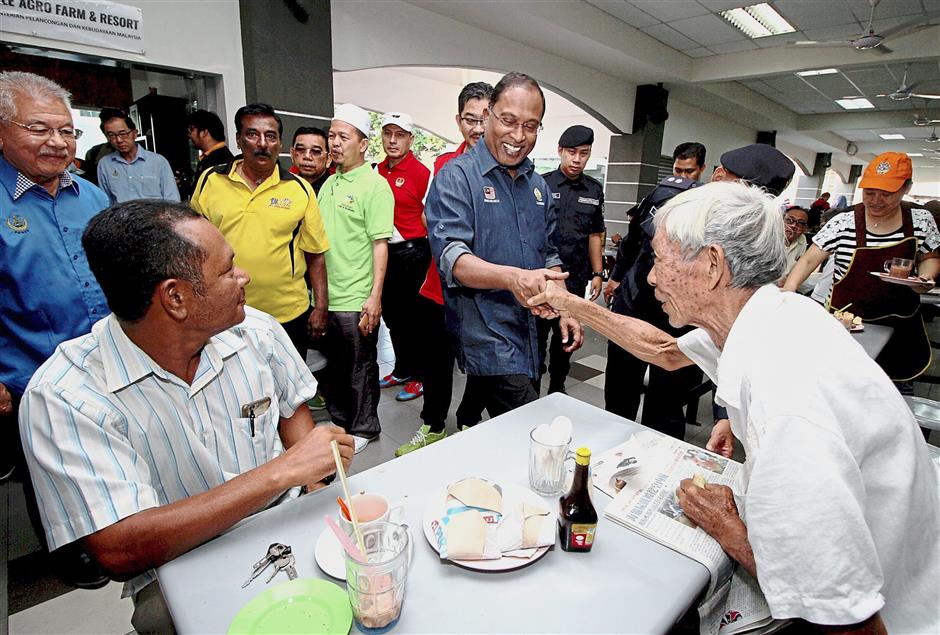 Zambry (centre) meeting customers at Datuk Sagor food court after planting the Ipoh Tree.