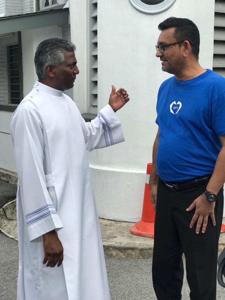 Shah Kirit speaking to Fr George Packiasamy during the visit.