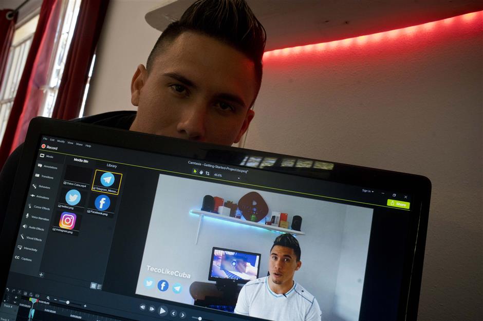 In this Wednesday, Feb. 20, 2019 photo, Julio Aguirre Lusson, 25, a DJ who has had a YouTube channel called TecnoLikeCuba for a year, poses for a photo in his house in Havana, Cuba. 'Previously, the country with the most subscribers to my channel ... was Spain, followed by the United States, and Cuba third. Now the highest number are Cubans,' he said. (AP Photo/Ramon Espinosa)