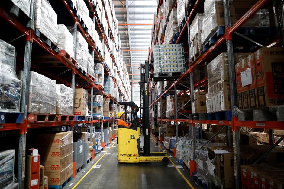 A worker uses a forklift to collect items at online retailer Lazada's warehouse in Depok, south of Jakarta, Indonesia March 26, 2018. Picture taken March 26, 2018. REUTERS/Darren Whiteside