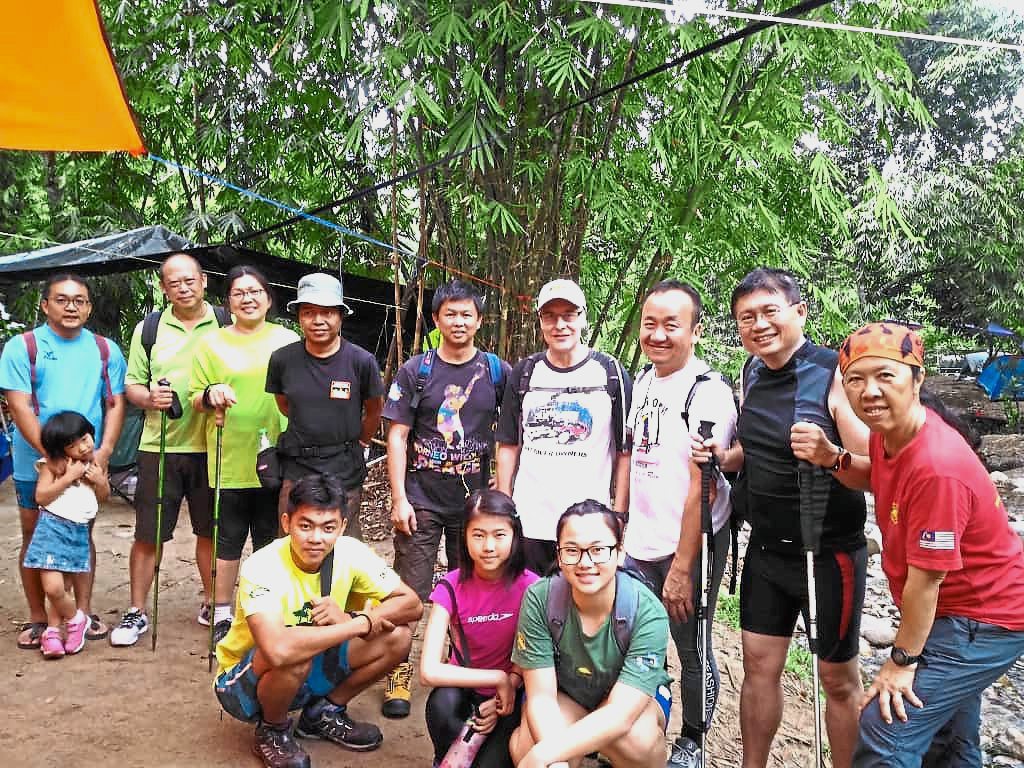 Tai (right, in red) and fellow club members at their campsite in Bukit Kutu.