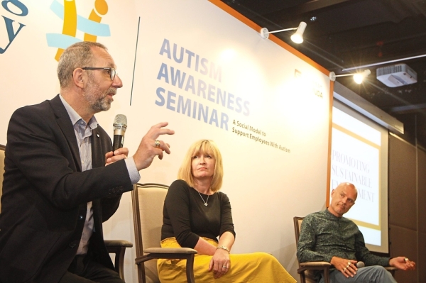 Keen interest: Bates answering questions from the floor during the Enabling Academy’s Autism Awareness Seminar at Menara Gamuda in Petaling Jaya. With him are Runswick-Cole and Goodley. The University of Sheffield professors and researchers were in town to speak at the seminar.