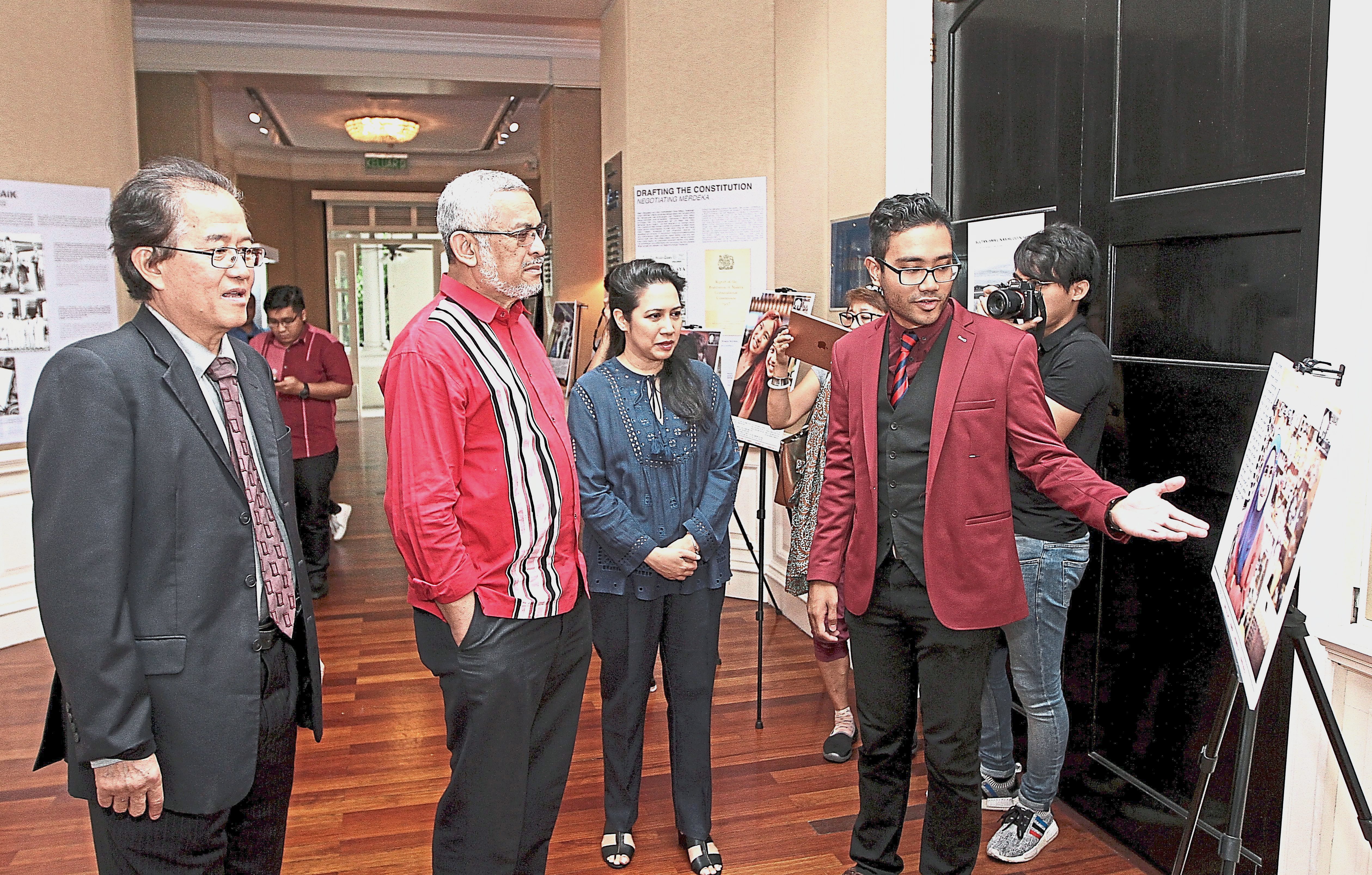 Khalid (second from left) checking out the photo stories at the exhibition. He is accompanied by Asian Heritage Museum (AHM) chief executive officer KK Tan (far left), Sunita (third from left) and Mushamir (second from right). — Photos: YAP CHEE HONG/The Star