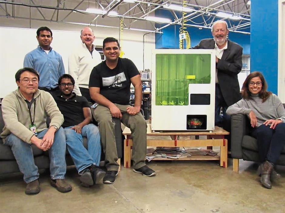 K. Kathirgugan (sitted 2nd right) with Deepak Sekar (sitted on his left) and the team with Sally, the first salad making robot in the world in December 2015. Tai Yen Chung is on Kathirgugans right.