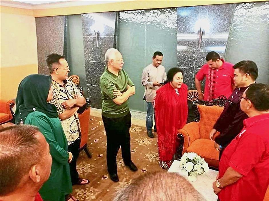 Pleased to meet you: Najib and Rosmah after arriving at the hotel from Langkawi Airport in this picture obtained from a Facebook posting by Nor Saidi Nanyan.