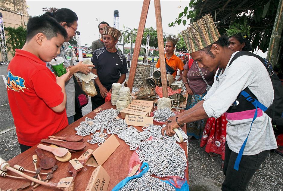 Visitors checking out handicraft made by orang asli at the event.