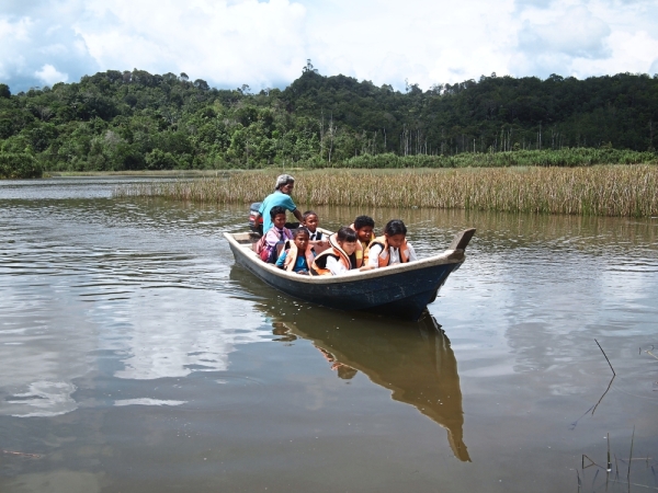 Far from school: Some orang asli children from villages near Tasik Chini, Pahang, have to take a boat to reach their school.