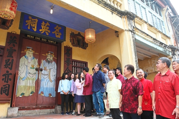 Yeap (third right) and other clan members posing in front of Meng Eng Soo Temple in Jalan Pintal Tali. —  Photos: ZHAFARAN NASIB/The Star