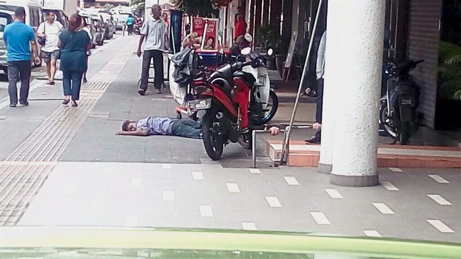 Drunks sleeping on sidewalks are a common sight in Brickfields.