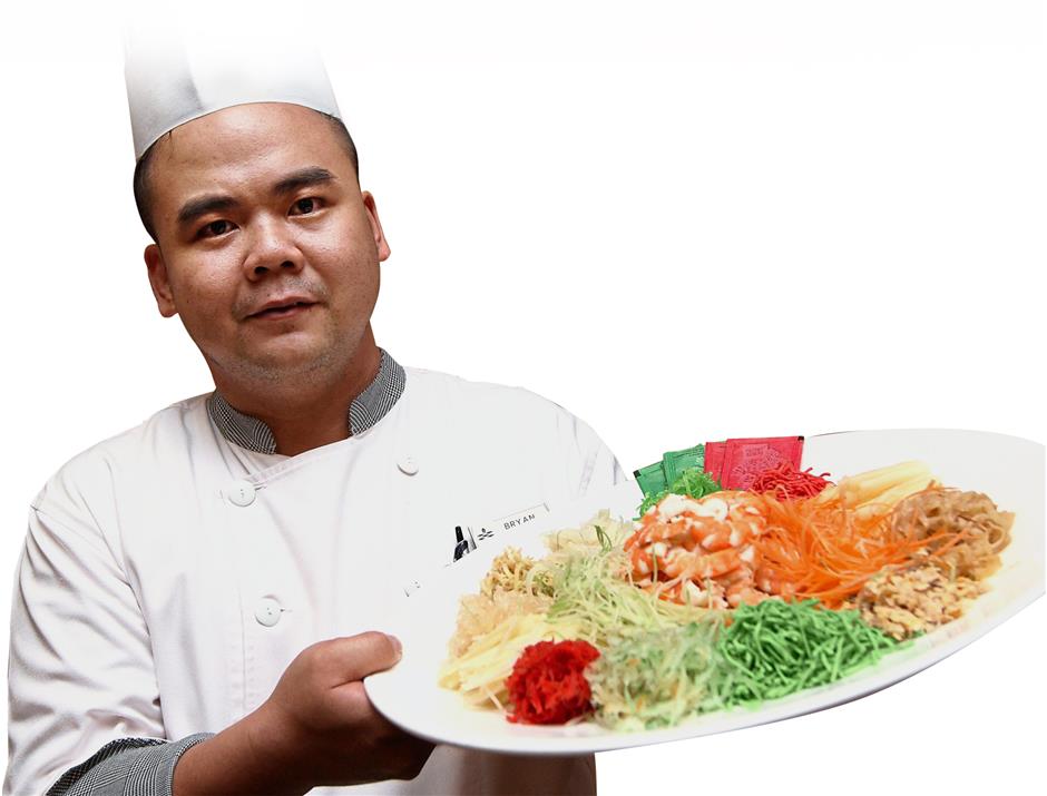 Teh holding up a plate of Hee Har Yee Sang with Pink Prawn and Fresh Fruit. — Photos: SAMUEL ONG/The Star