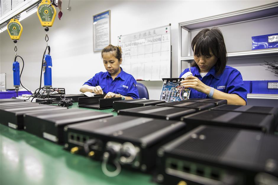 Technicians assemble main control modules for unmanned surface vessels at an Oceanalpha Co. facility in Zhuhai, China, on Thursday, May 18, 2018. Oceanalpha, one of a handful of companies around the globe specializing in ocean-going drones that operate on the surface, has fired the interest of some of China's biggest venture capitalists. Photographer: Qilai Shen/Bloomberg